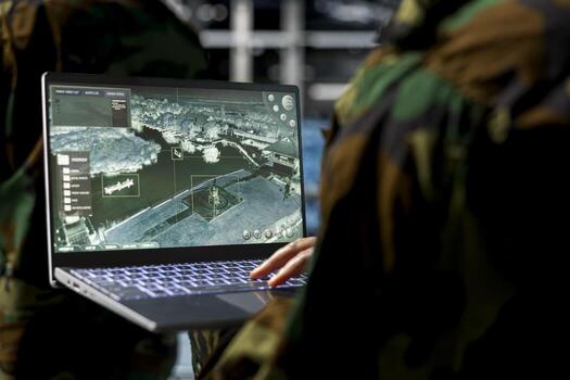 Close up of military technician in data center operating satellite control software from secure terminal. IT specialist monitoring orbital surveillance feeds in military server room photo