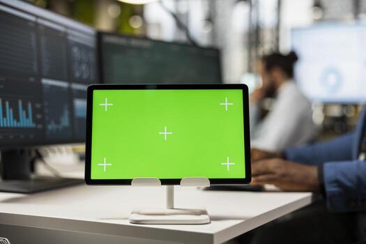 Close up of black businessman examines reports on graphs with chroma key on tablet, building a new business strategy for global development. Objectives alignment with productivity. photo