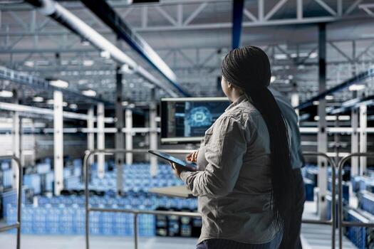 Data center software developer using tablet to upgrade configuring storage devices for minimal latency in AI workloads. IT expert using device in server room to build neural networks photo