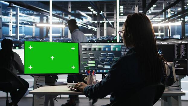 Server hub programmer using node tree software on isolated screen PC to optimize system health. Data center employee analyzing equipment issues using AI visualization on chroma key computer, camera A photo