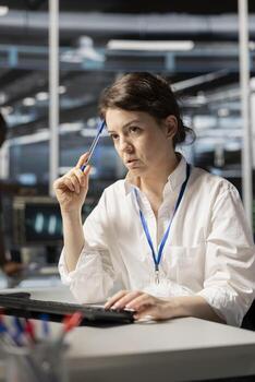 Data center technician doing brainstorming on how to fix gear, doing maintenance tasks. Server farm employee thinking how to repair network rigs after conducting system checks photo