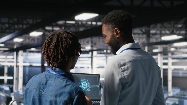 Data center team on industrial platform collaborating to maintain servers using artificial intelligence. Engineers cooperating to support infrastructure AI machine learning automatization photo