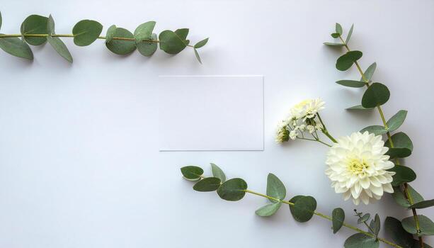 Creative layout made of flowers and leaves with paper card note flat lay on white background featuring natural floral elements and space for text, ideal for greeting cards, invitations, stationery photo