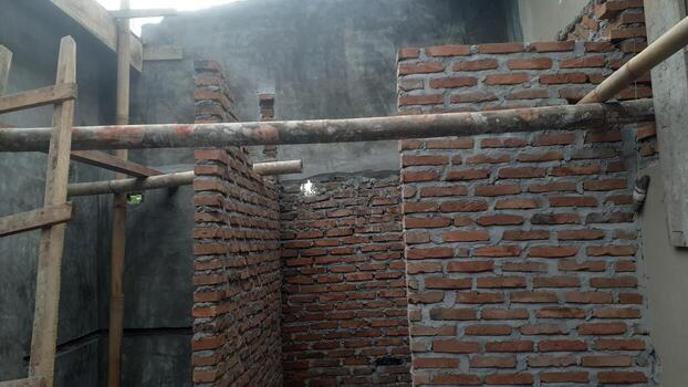 Brick Walls and Bamboo Scaffolding at Building Construction Site photo