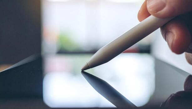 Macro photo of stylus writing on digital tablet screen, highlighting modern technology, creative design tool, digital illustration concept, productivity device, and innovation detail.
