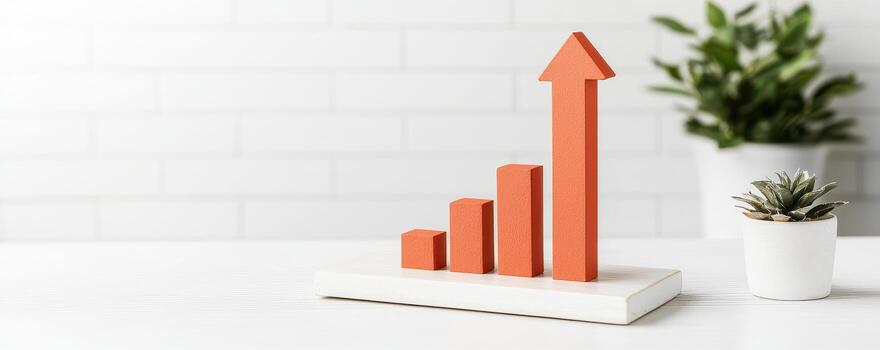 Growing red bar graph with arrow on desk, symbolizing success photo