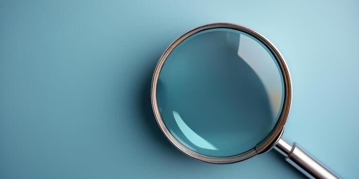 close up view of magnifying glass on blue background photo