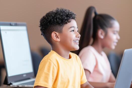 child smiling while attending virtual class on computer photo