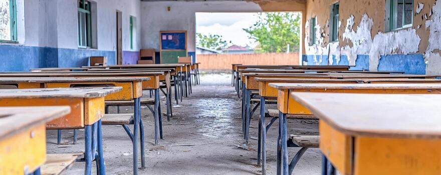Empty classroom with broken desks in remote school setting photo