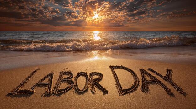 Labor Day written on the beach at sunset, waves are coming in photo