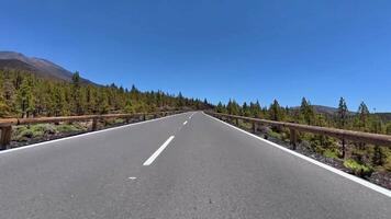 A road with a bridge over it and trees in the background video