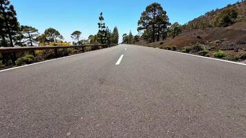 A beautiful road winds through lush trees and breathtaking landscapes, perfect for travel and adventure video