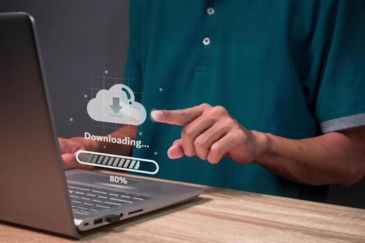 Man using a laptop to download data from cloud storage. Cloud technology and data storage concept. photo