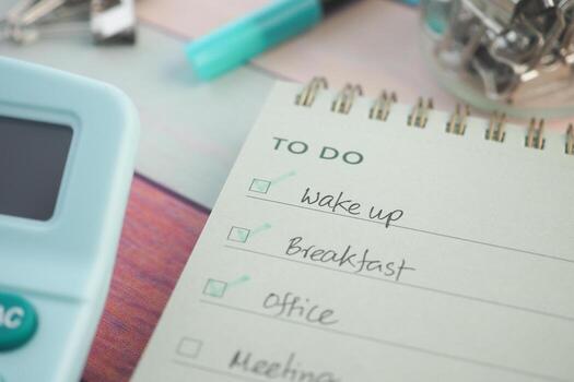 Grocery list and to-do tasks on a workspace notepad photo