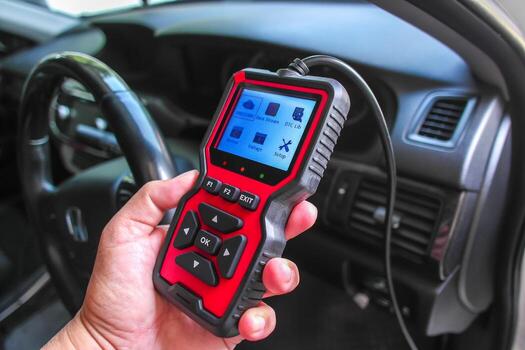 OBD2 scanner in hand, car diagnostic tool and code reader to check engine light, read and clear DTCs, view live data and voltage photo