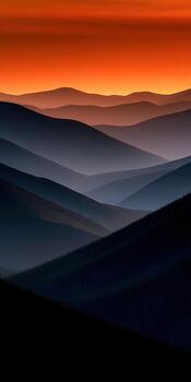 Layers of mountains at dusk glow in vibrant colors photo