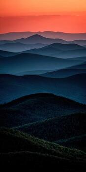 Vast mountain range at sunset with layered hills photo