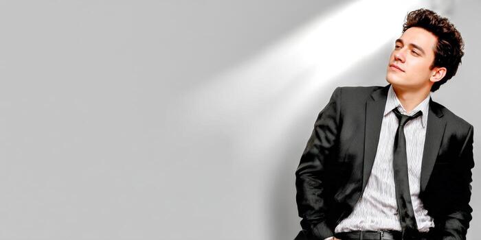 Man in suit looks towards light photo