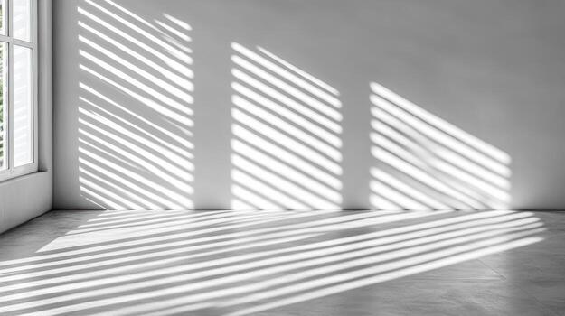 Sharp window blinds casting parallel shadows create striking visual effect in minimalist room photo