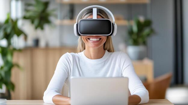Virtual reality user smiling while wearing headset and using laptop in modern workspace photo