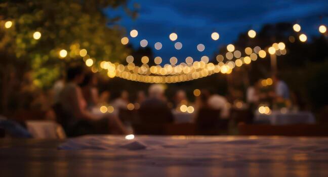 Cinematic bokeh of warm string lights illuminating an intimate outdoor evening party photo
