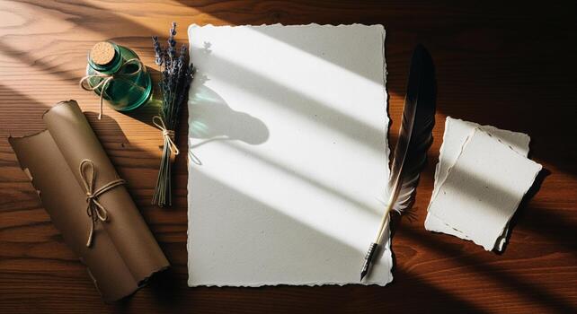 Vintage writing setup with blank handmade paper, quill pen, and scroll on wooden desk photo