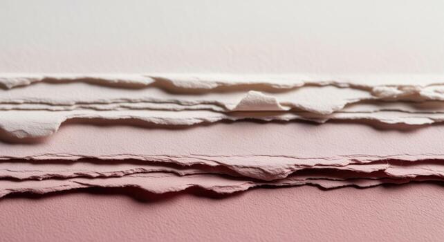 Abstract macro of layered textured paper with distressed peeling edges in cream and pink tones photo