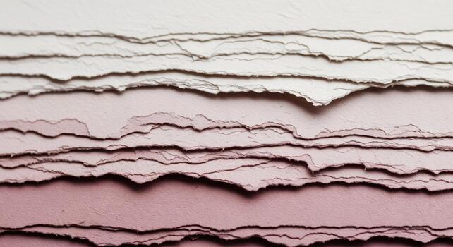 Textured layered paper with torn distressed edges showing a cream to pink color gradient photo
