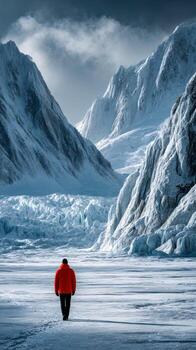 Man walking in snowy mountain valley photo