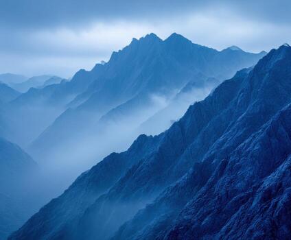 Mysterious blue mountain range under cloudy sky photo
