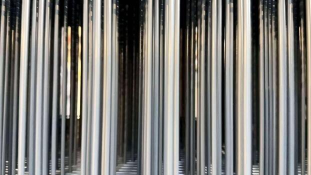 A stunning visual of metallic columns reflecting light, creating an exceptional abstract aesthetic that captivates photo