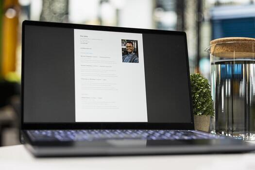 Close up of laptop in empty space shows applicant CV before hiring interview, office used for the recruitment process and reviewing qualifications or work experience to align with position. photo