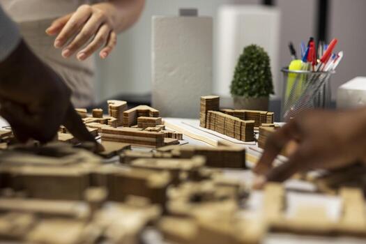 Close up of contractors arranging layout for a housing master plan, simulating site preparation with architectural 3D models before the construction. City planning and modern redevelopment. photo