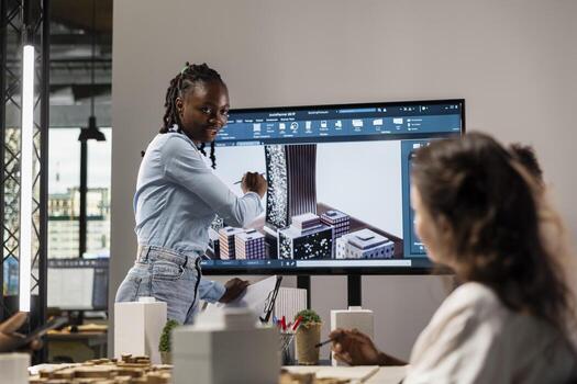 Black property developer discussing residential project investment and strategy for infrastructure growth and city planning in a bright office setting, analyzing blueprints and 3D models. photo