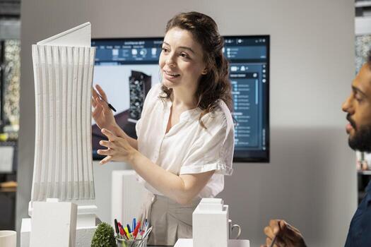 Diverse team of developers sharing construction details in a briefing session, urban development vision using advanced architectural software and 3D models for a modern housing project. photo