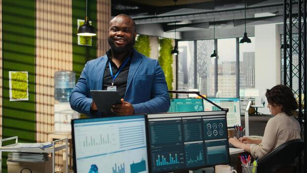 Corporate professional analyzes efficiency through charts and graphs to prepare monthly reports, utilizing strategic data insights to improve management practices in a modern office. photo