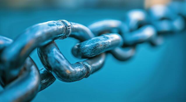 Close-up View of a Metallic Chain With a Focus on Links and Texture in Blue Tones photo