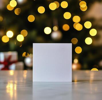 Blank Card in Front of a Decorated Christmas Tree With Glowing Lights and Ornaments. photo