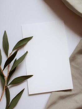 Elegant boho invitation mockup with greenery on a soft textured background photo