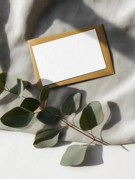 Elegant boho invitation mockup with gold border and greenery on soft fabric background photo