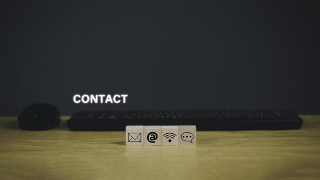 Contact us or e-mail marketing concept. Customer support hotline Contact us people connection. cube wood with the email, call phone, address, Chat message icons. on keyboard computer. photo