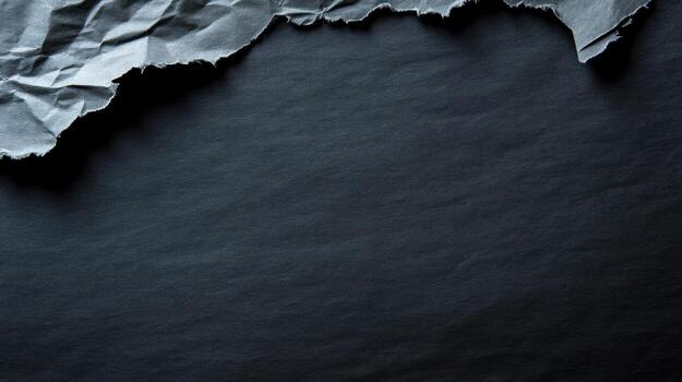 torn grey paper on dark background photo