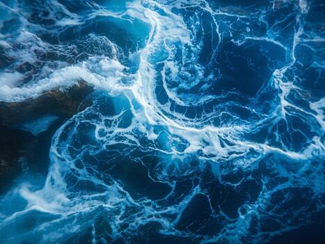 Dynamic ocean waves create a mesmerizing pattern of white foam and deep blue water. photo