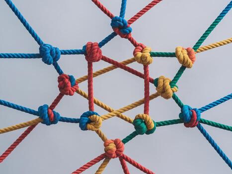 A colorful arrangement of ropes in various knots creating an intricate geometric pattern. photo