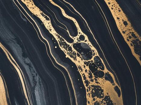 Abstract black and gold marbled texture with flowing lines and bubbles creating an elegant design. photo