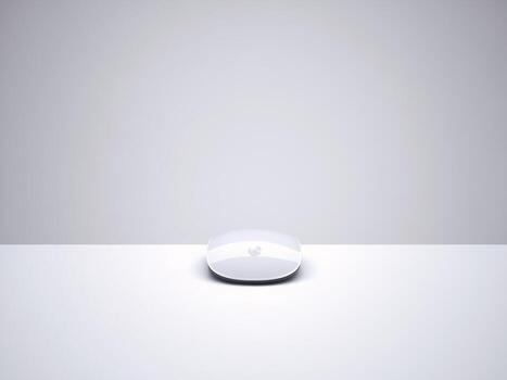 A sleek, glossy white device resting on a minimalistic white surface with a soft glow. photo