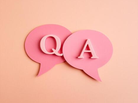 Pink speech bubbles with letters Q and A representing a question and answer format. photo