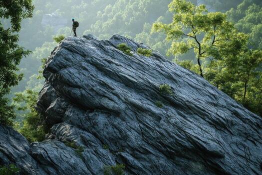 A man standing on top of a mountain photo