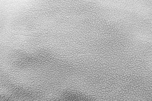 Textured surface of gray leather material with subtle patterns and variations photo