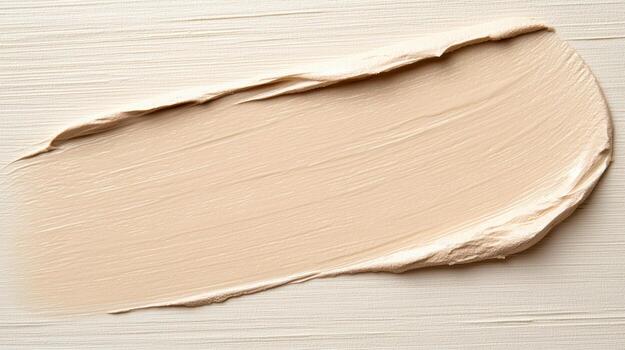 A cream foundation is being applied to a white surface photo